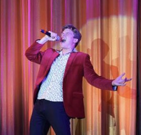 Junior Alex Meckes sings onstage at Lamorinda Idol.
