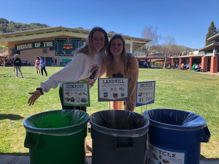 Juniors Evelyn Lavelle and Christine Pearson smile for a picture while monitoring trash bins during lunch. 