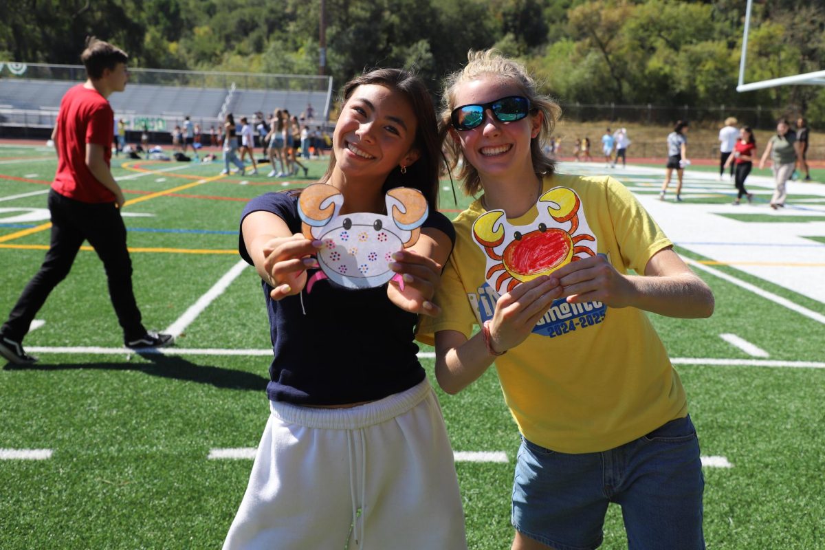 Ninth-grader Ellie Letulle and her Link Crew Leader, Phoebe Wood, proudly display their scavenged paper crabs. Photo: Emma Wong