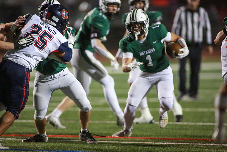 Junior Charlie Hwang takes off a handoff from junior quarterback Carson Blair. Photo: Mark Bell