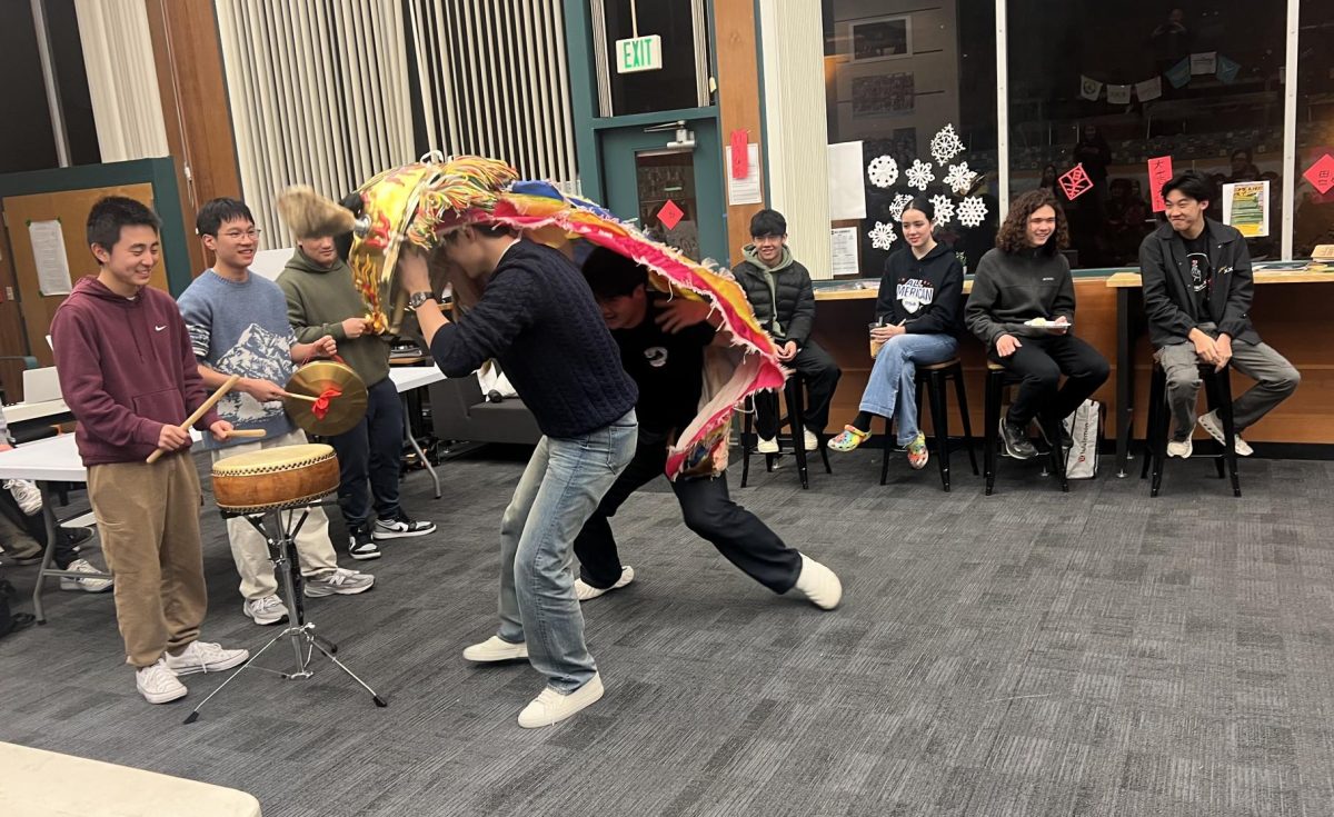 Juniors Hugo Shen and Alexander Lian perform a lion dance, accompanied by drums played by juniors Sam Cao, Anthony Chow, and Calvin Lai. Photo: Annie Strickler